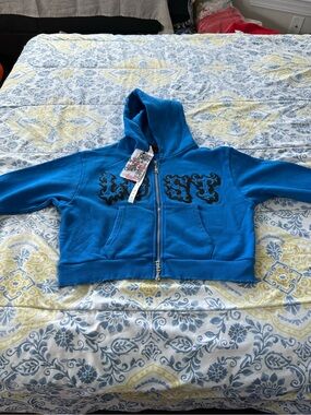 Lost Intricacy Woman’s Bright Blue Zip Hoodie with Black Decorative Applique